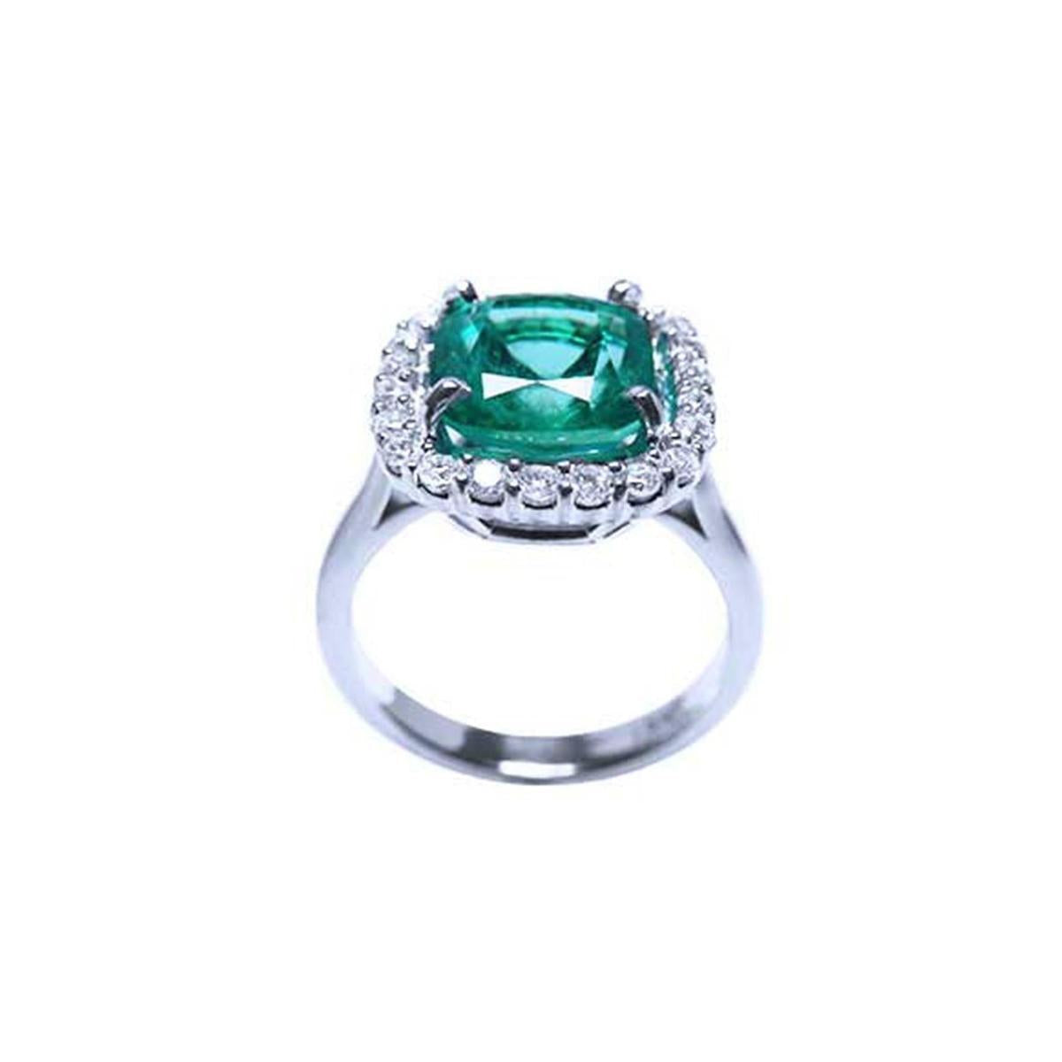 In this photo the emerald Cushion cut shows the side view of the ring, revealing the top of the gemstone and part of the ring band.