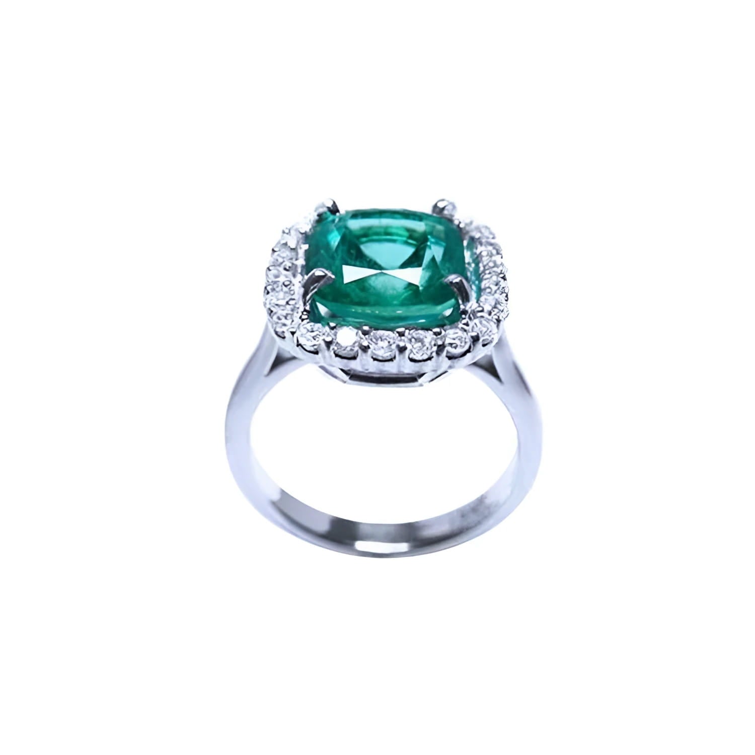 Cushion cut Colombian emerald ring with diamond halo in 18K white gold.