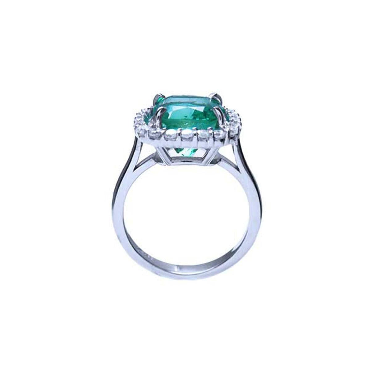 The position of this cushion cut emerald and diamond ring is lateral displaying the top and gallery profile.
