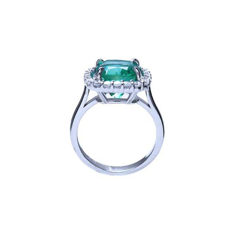 3.69 ct. cushion cut Colombian emerald engagement ring with diamond halo in 18K white gold.