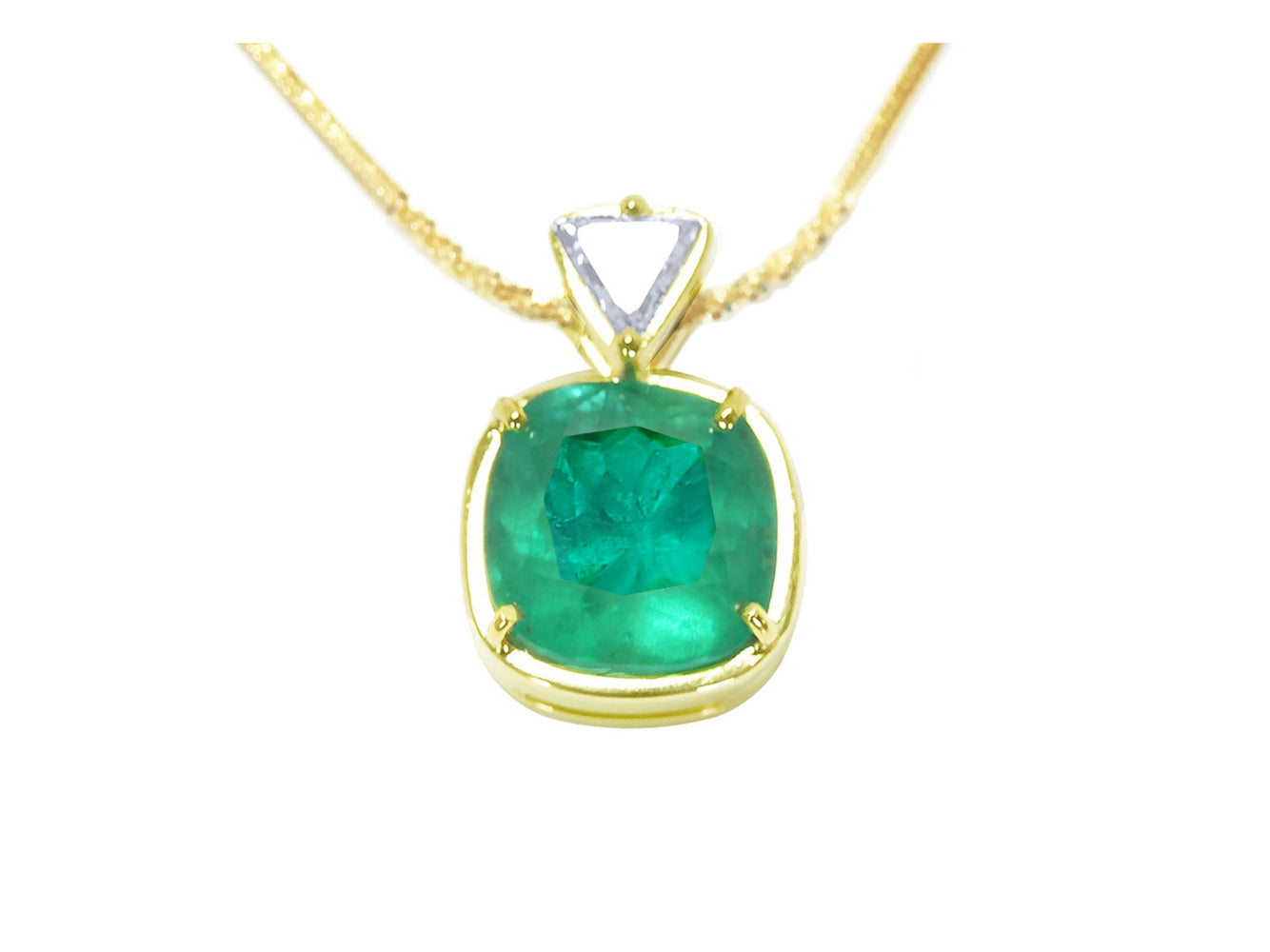 Gold necklace with a cushion cut natural emerald pendant on a white background