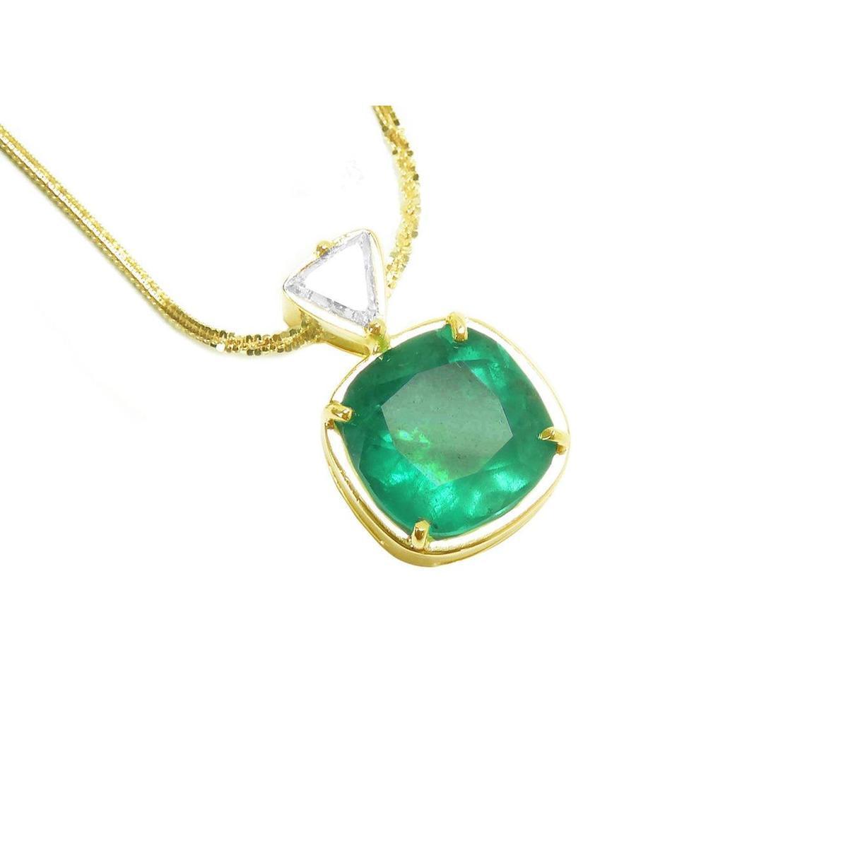 Gold necklace with a natural colombian emerald pendant on a white background