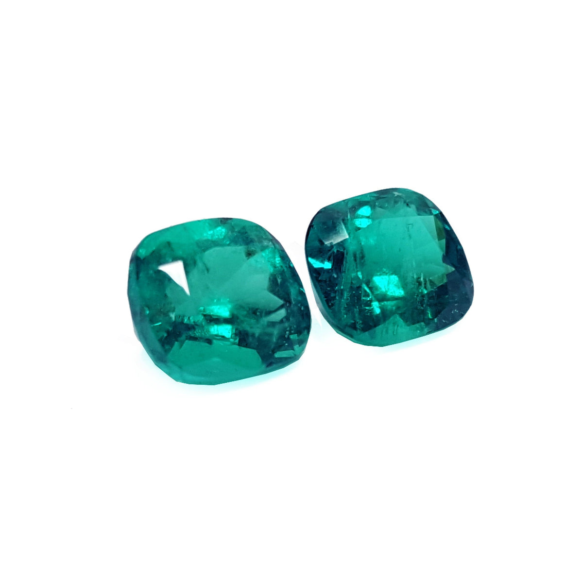Matching pair cushion cut loose emeralds