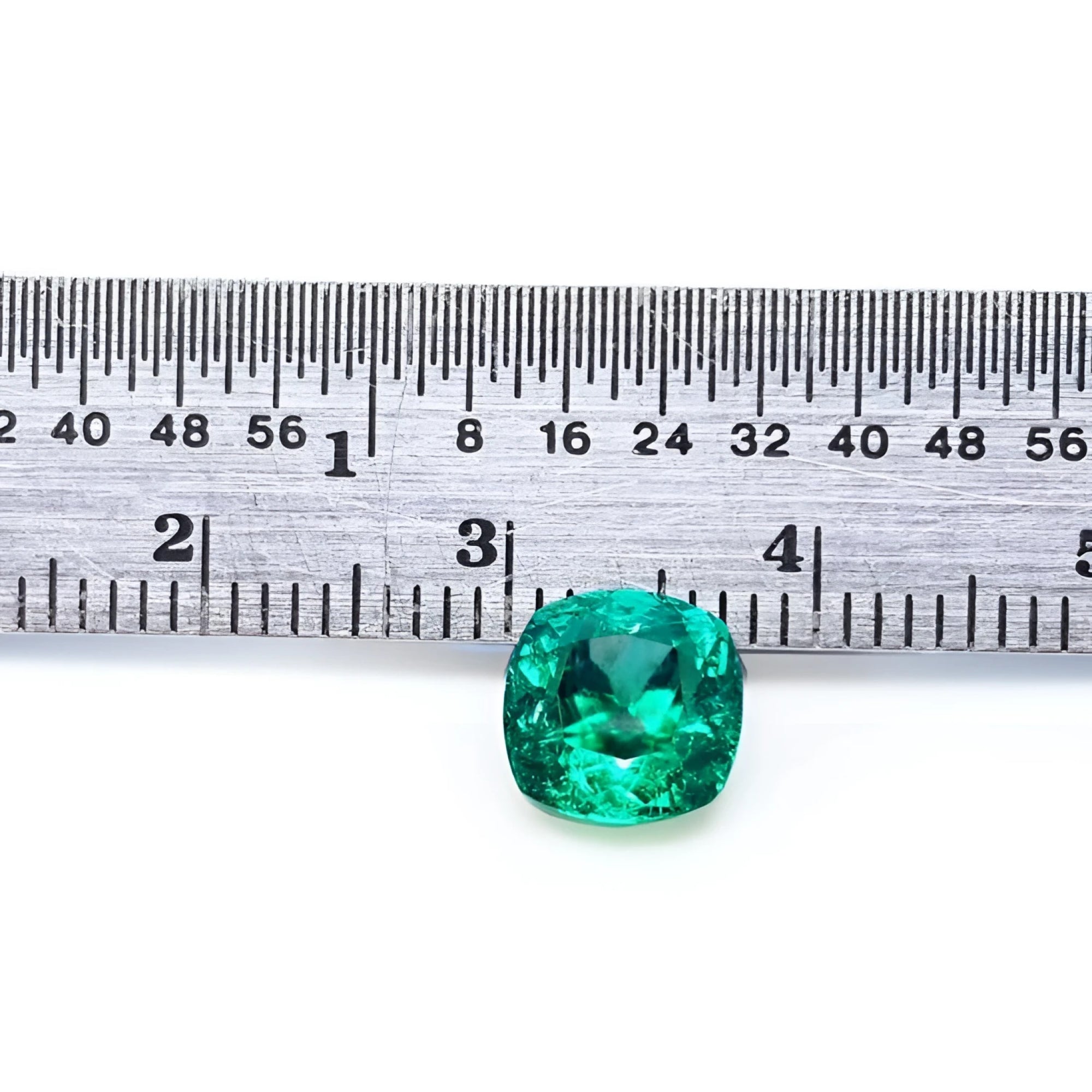 1.62 carat GIA certified emerald, cushion cut, vibrant medium-deep bluish-green, shown with ruler for scale.