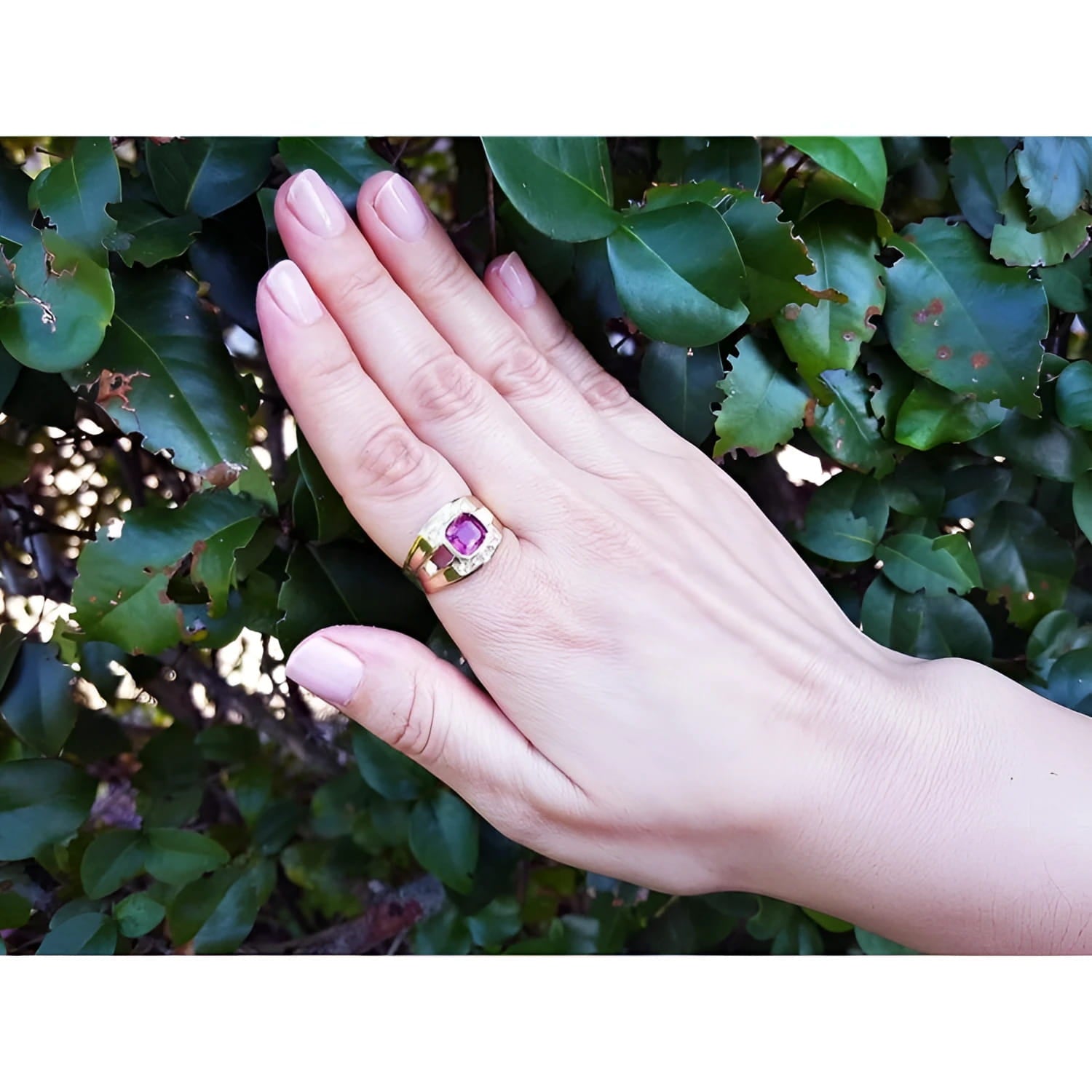Men's 18K yellow gold ring with a bezel-set cushion-cut purplish-pink sapphire and diamond accents.