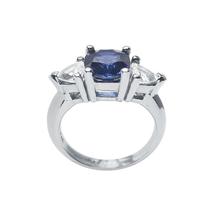14K white gold cushion cut deep blue sapphire ring with two trillion side sapphires.
