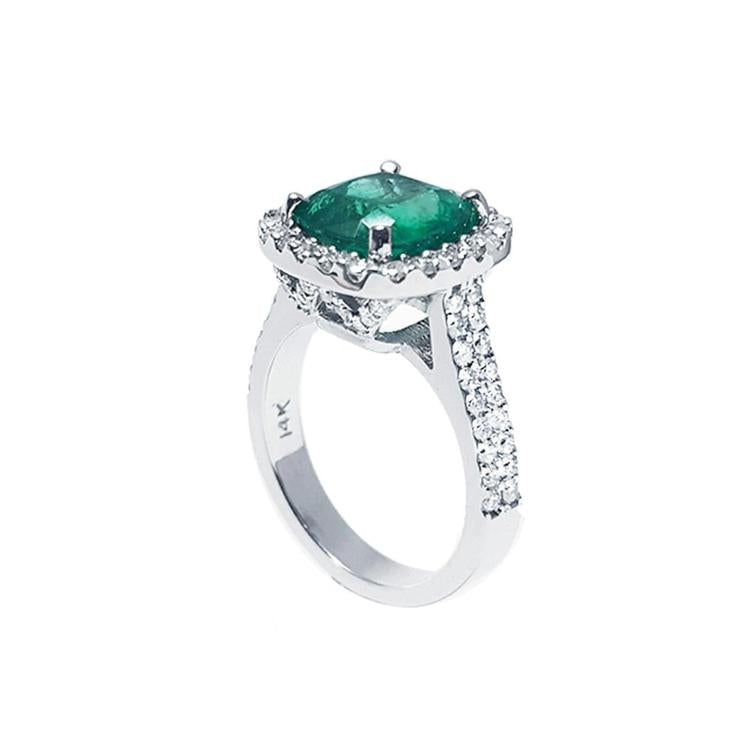 Cushion cut 3.92 ct. natural deep bluish green emerald ring with diamond halo in 14K white gold.