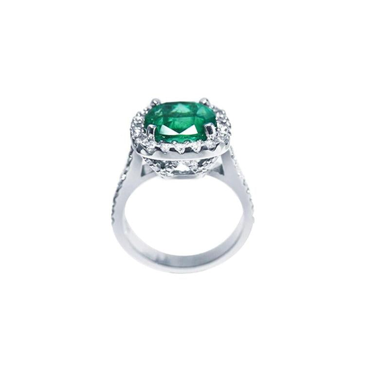 A white gold cushion cut emerald ring lateral side, top and gallery view.