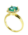 This 14k yellow gold cushion cut emerald ring is showing its lateral profile from the top to the band.