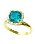 This natural cushion cut emerald ring is tilted to one side, displaying its profile.