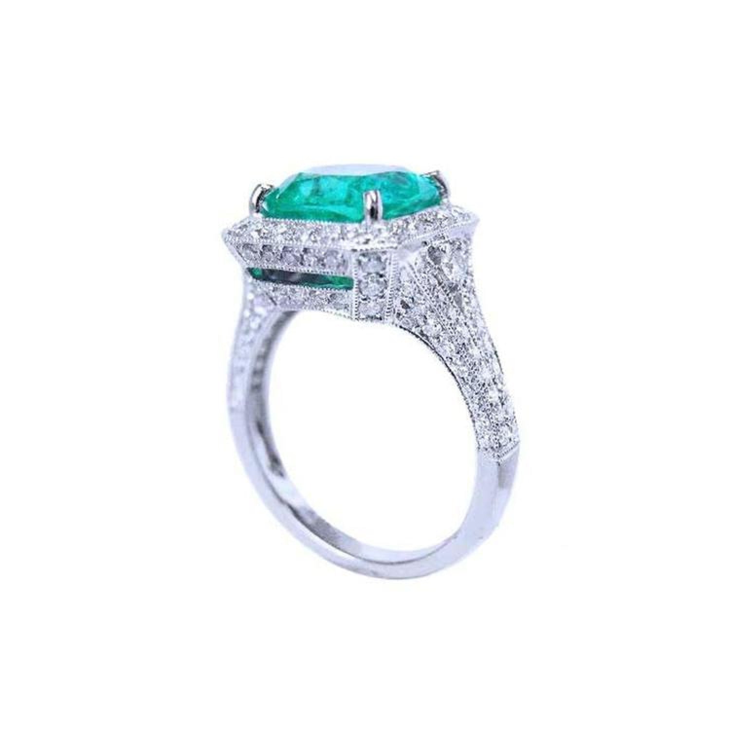 Cushion cut 3.68 ct emerald engagement ring in 18K white gold with diamond halo and pave band.