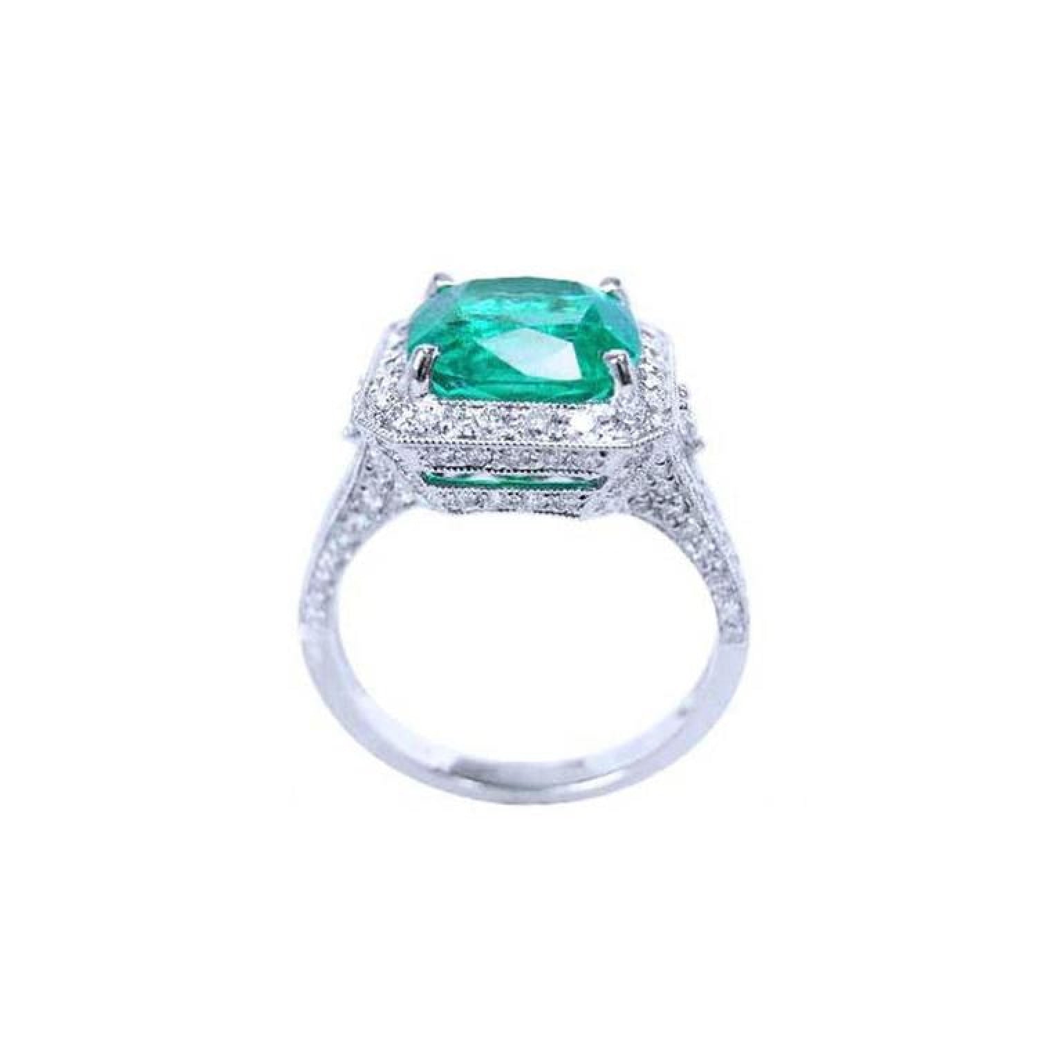 Cushion cut 3.68 ct Colombian emerald engagement ring with diamond halo in 18K white gold.