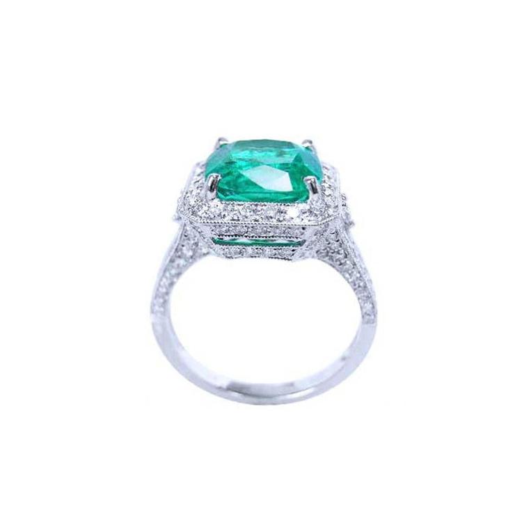 Cushion cut 3.68 ct Colombian emerald engagement ring with diamond halo in 18K white gold.