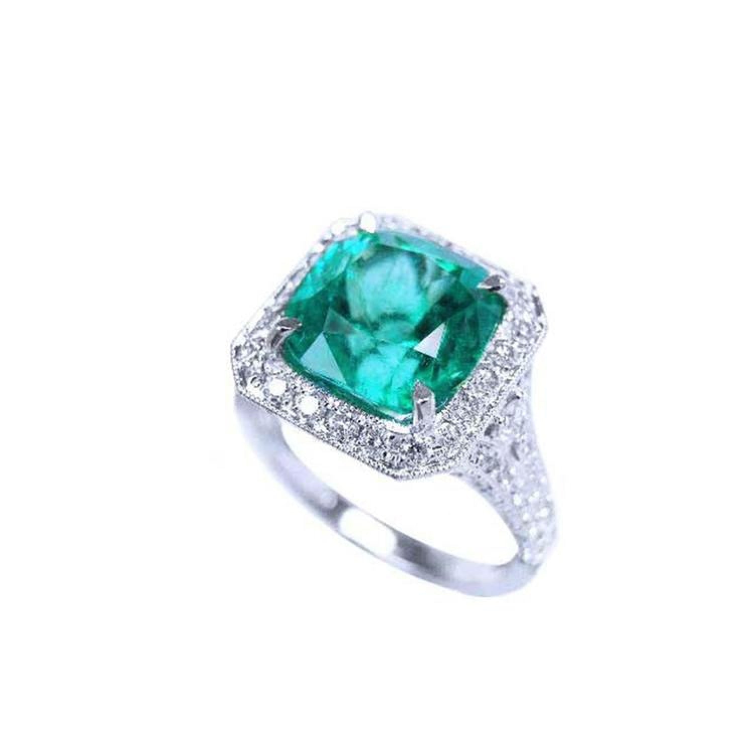 Cushion cut 3.68 ct Colombian emerald ring with diamond halo and pavé band in 18K white gold.