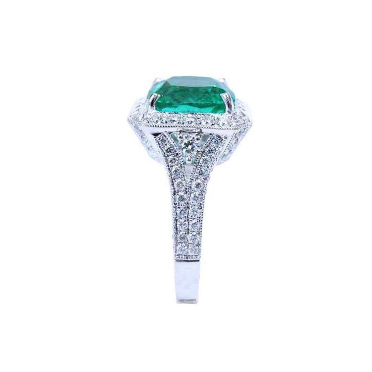 Cushion cut 3.68 ct Colombian emerald engagement ring with diamond halo and pavé band in 18K white gold.