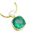 18k yellow gold necklace with a natural colombian emerald pendant and a trillion top diamond.