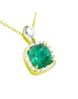 A 14k yellow gold pendant with a cushion cut natural emerald in the center surrounded by a halo diamond.