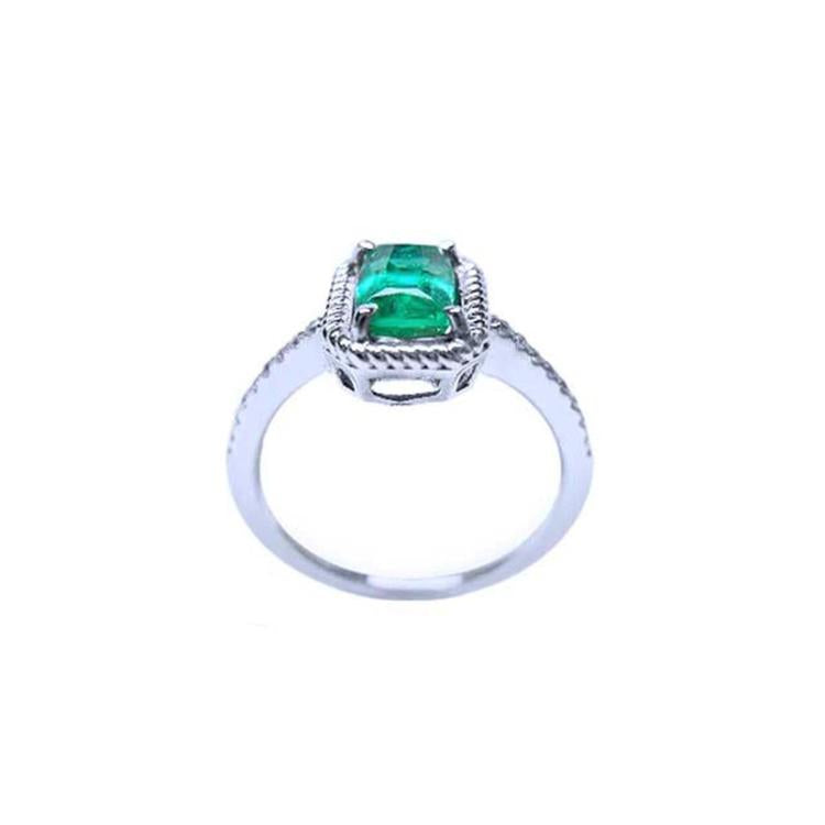 14K white gold cushion-cut emerald solitaire ring with distinctive rope detailing.
