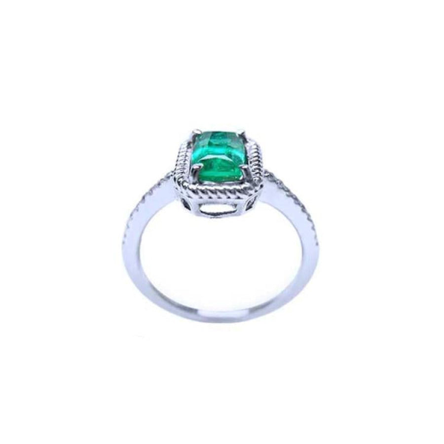 14K white gold cushion-cut emerald solitaire ring with distinctive rope detailing.