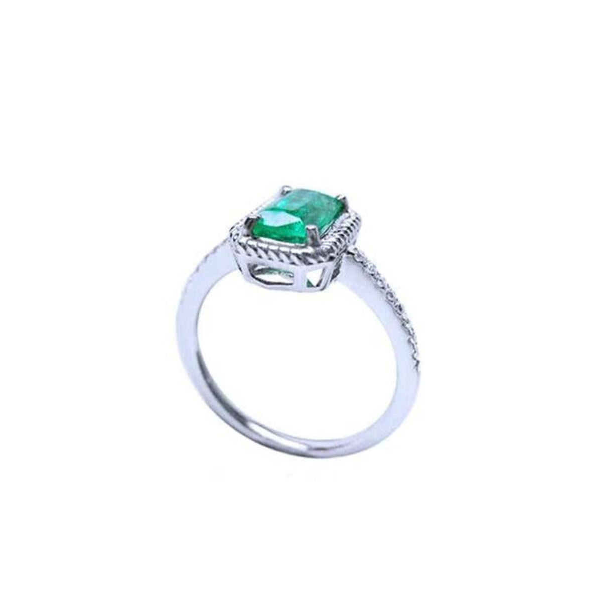 14K white gold solitaire ring with a cushion-cut emerald and rope detailing.