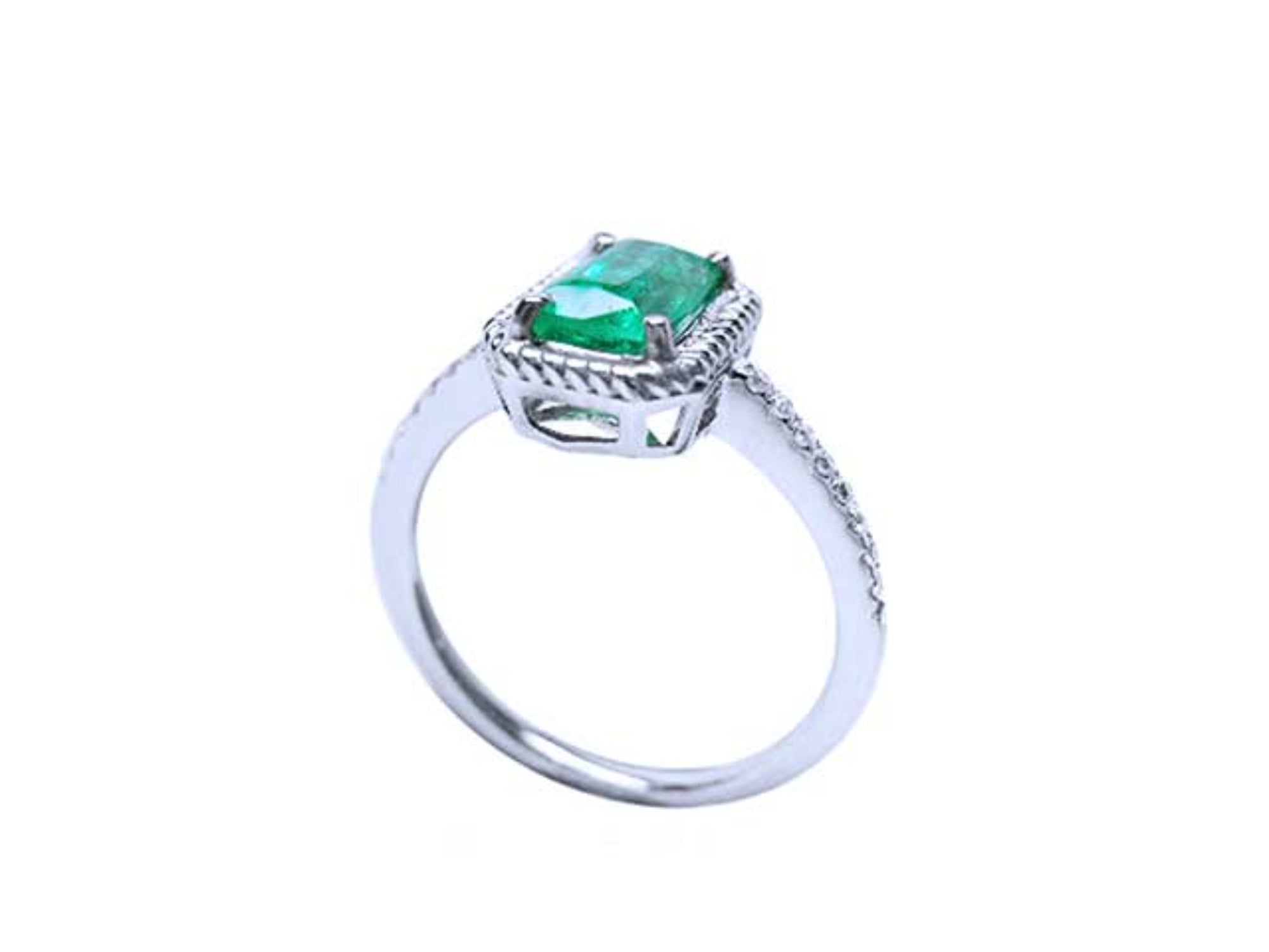 The half side of a cushion cut emerald solitaire ring showcasing the top and gallery with band profile.
