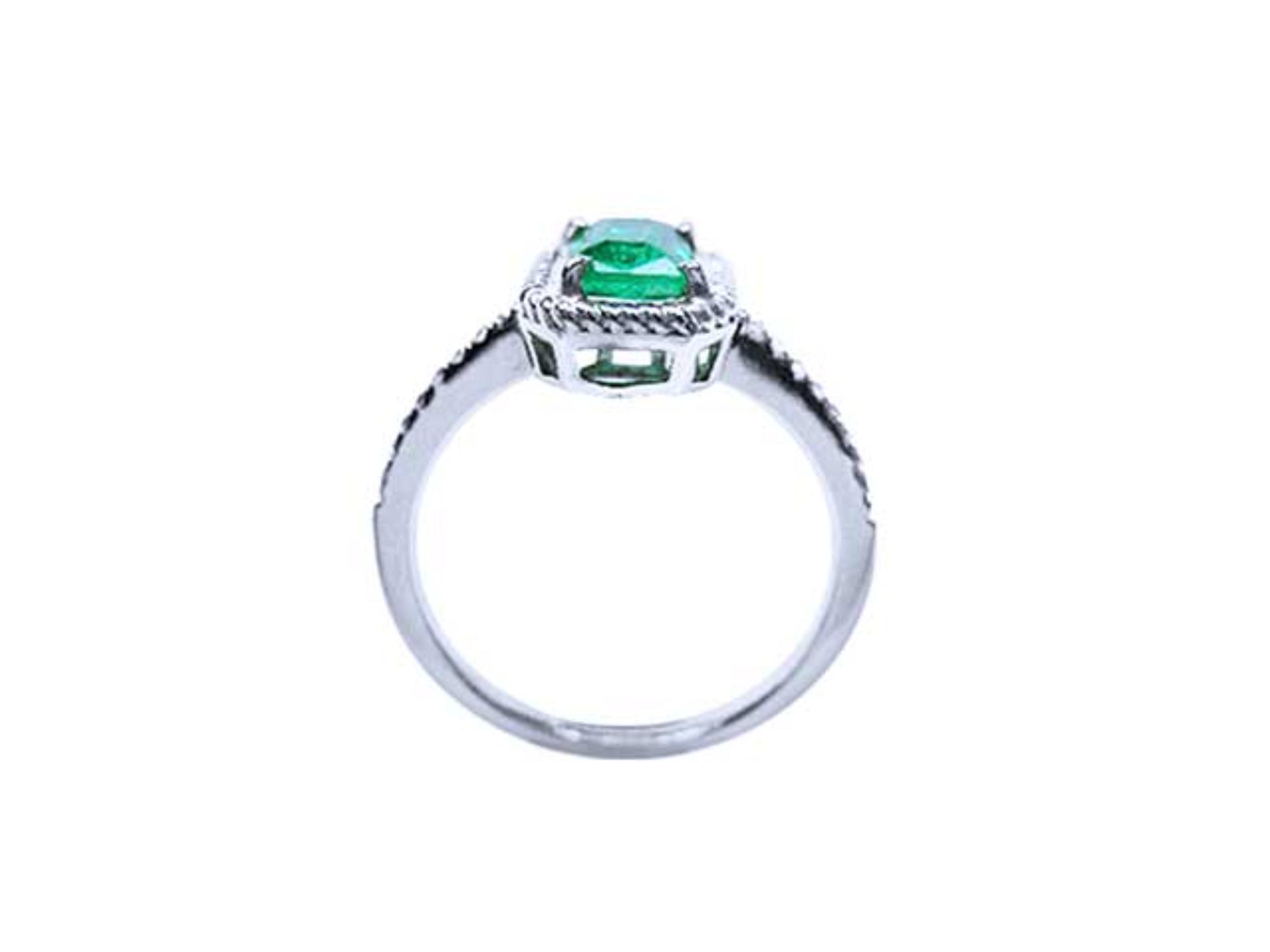 The top setting. gallery and band displayed in this cushion cut natural emerald ring in white gold.