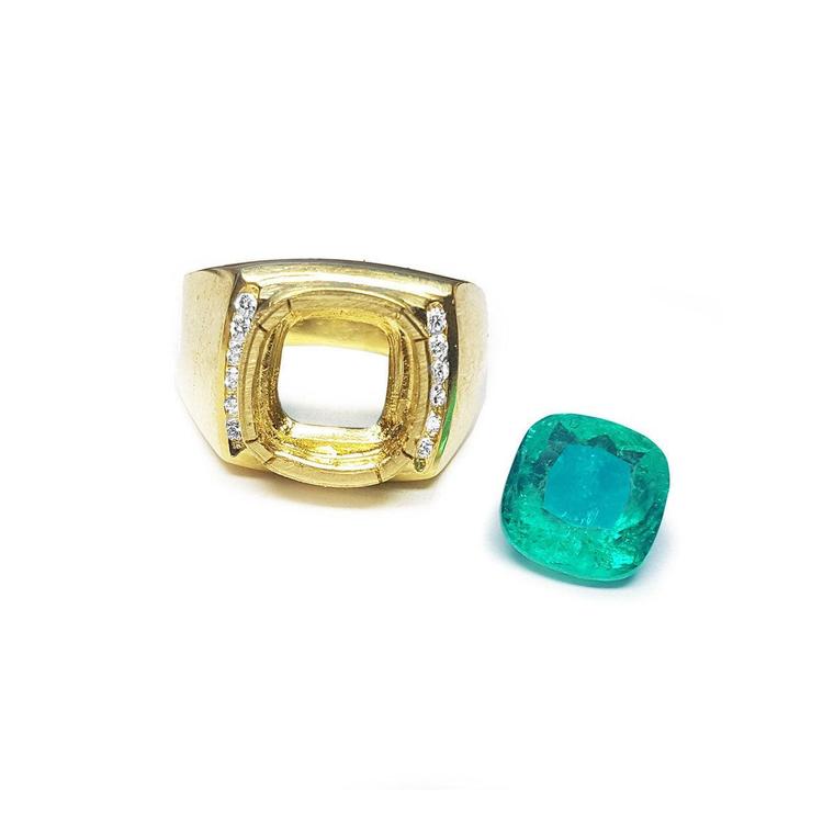 Gold ring mounting for men with emerald stone aside on a white background.