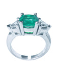 Top and lateral profile view of a 14k white gold emerald three stone ring for women.