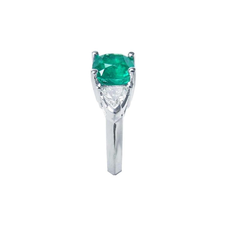 2.18 ct cushion cut emerald ring with trillion side diamonds in 14K white gold.