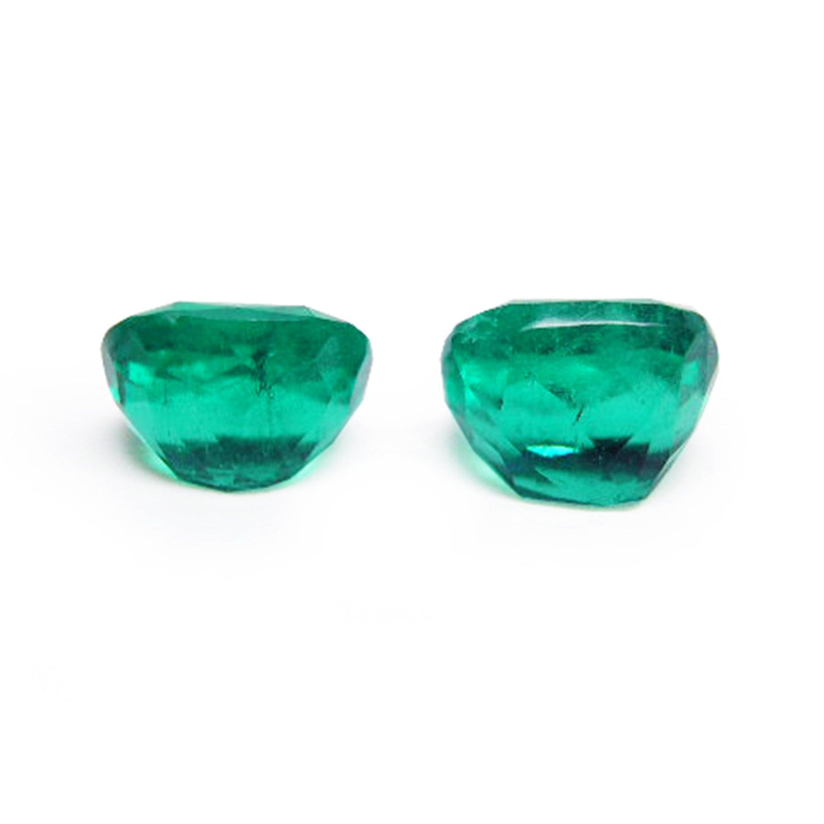 Matching pair cushion cut loose colombian emeralds underside girdle and pavilion view