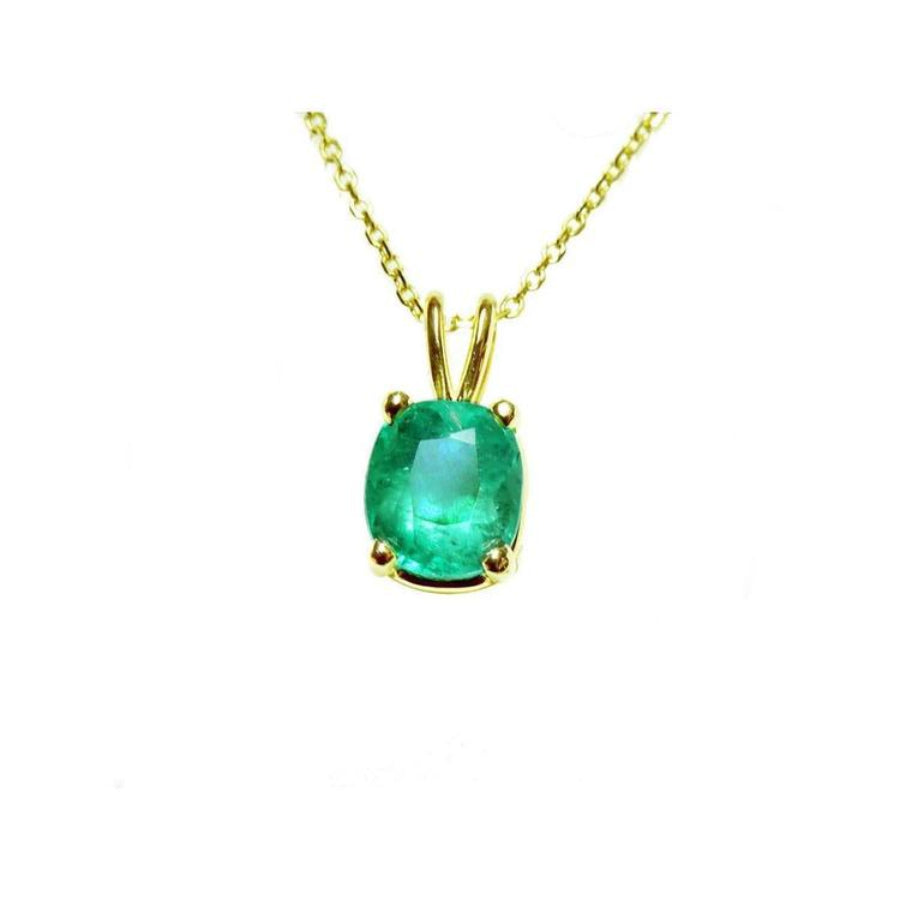 A 14k yellow gold natural Muzo mine colombian emerald cushion cut pendant prong set.