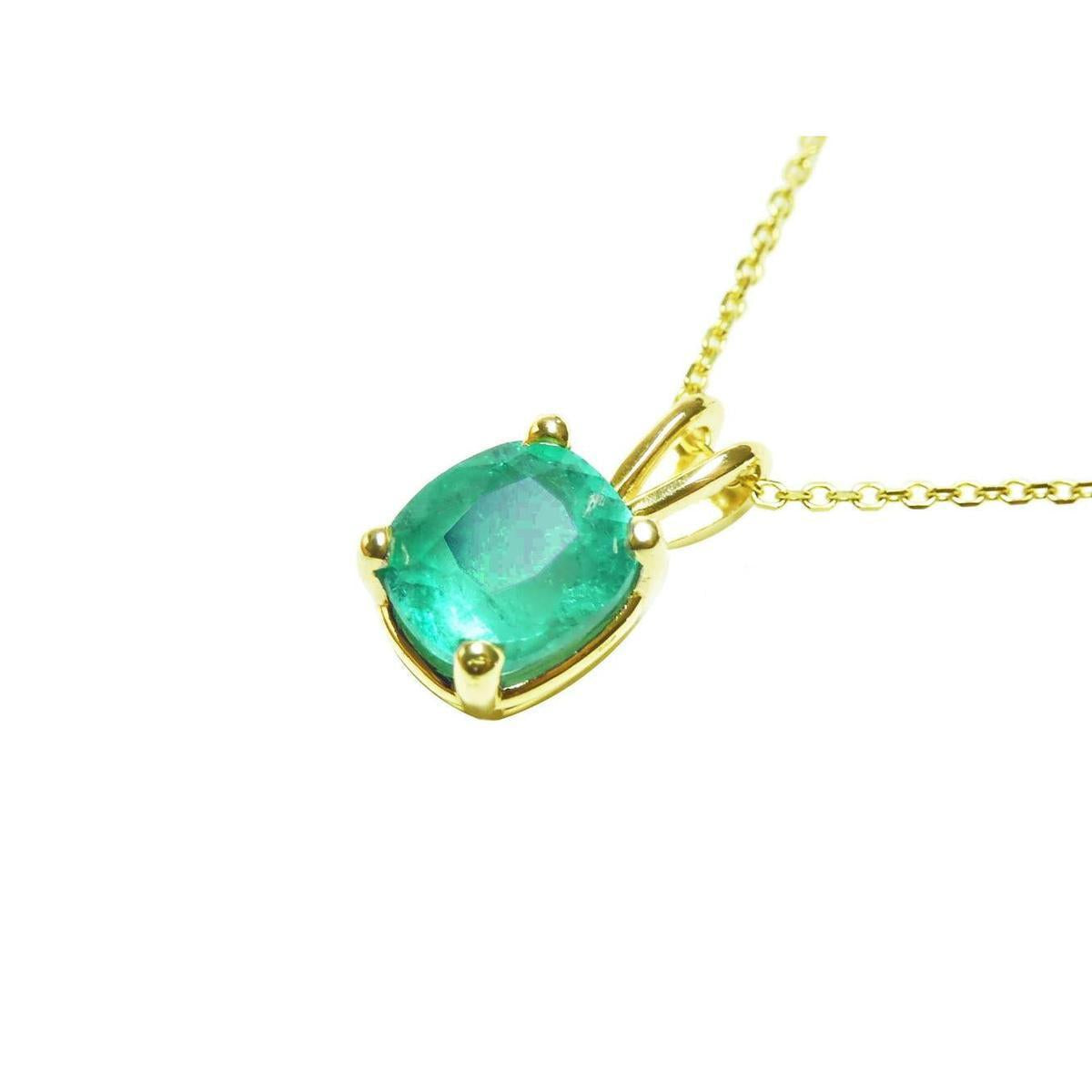 This solitaire emerald cushion cut pendant displays its left side profile, top and gallery perspectives visibles. 