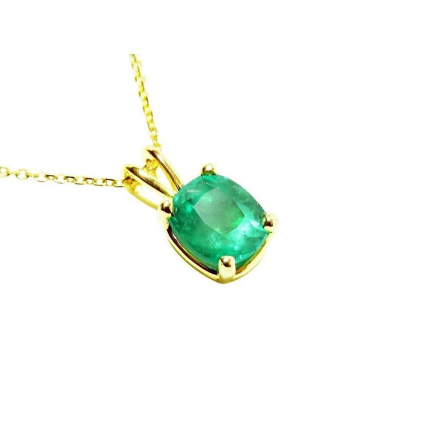 A cushion cut natural colombian emerald solitaire pendant prong set in a 14k yellow gold setting.