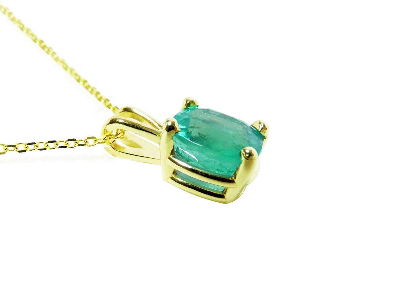 The left side profile of a cushion cut emerald solitaire pendant, top and gallery visibles.