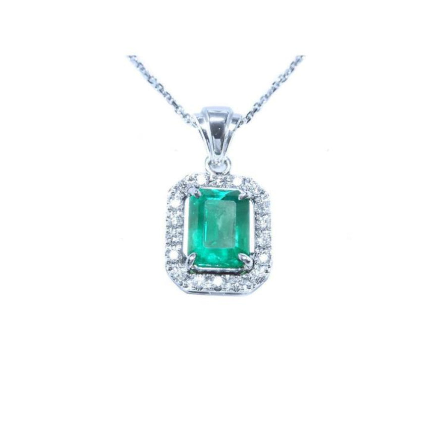 Emerald-cut emerald pendant with halo diamonds in 14K white gold on a chain.