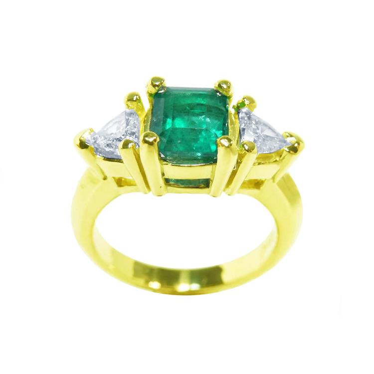 18k yellow gold natural colombian emerald and trillion cut side diamond ring for women.