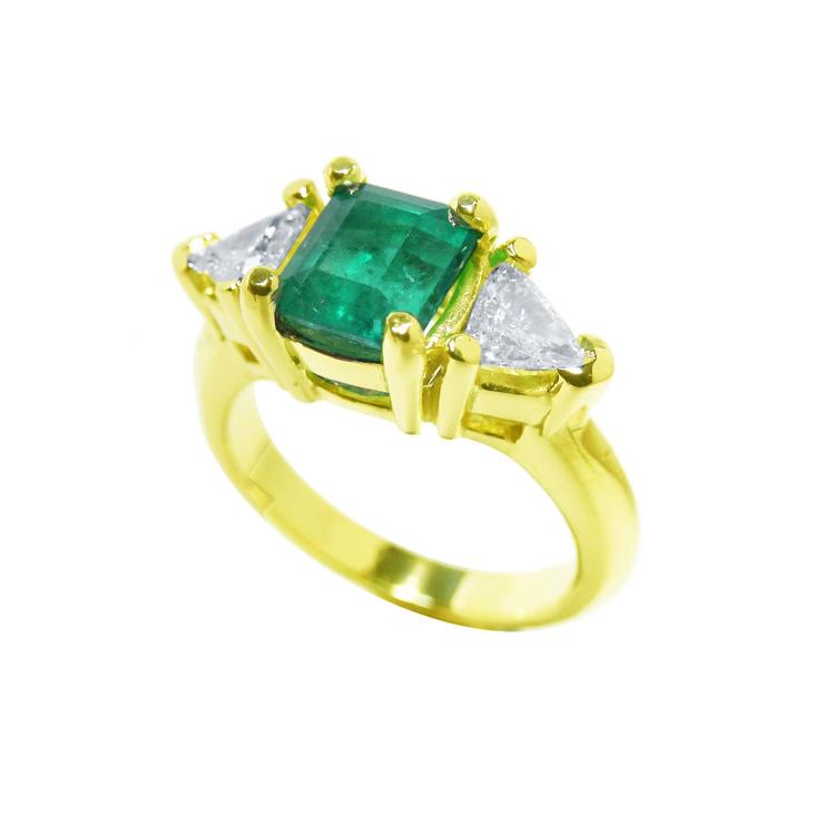 Muzo colombian emerald ring with side trillion natural diamonds in 18k yellow gold.