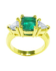 18k yellow gold natural colombian emerald and trillion cut side diamond ring for women.