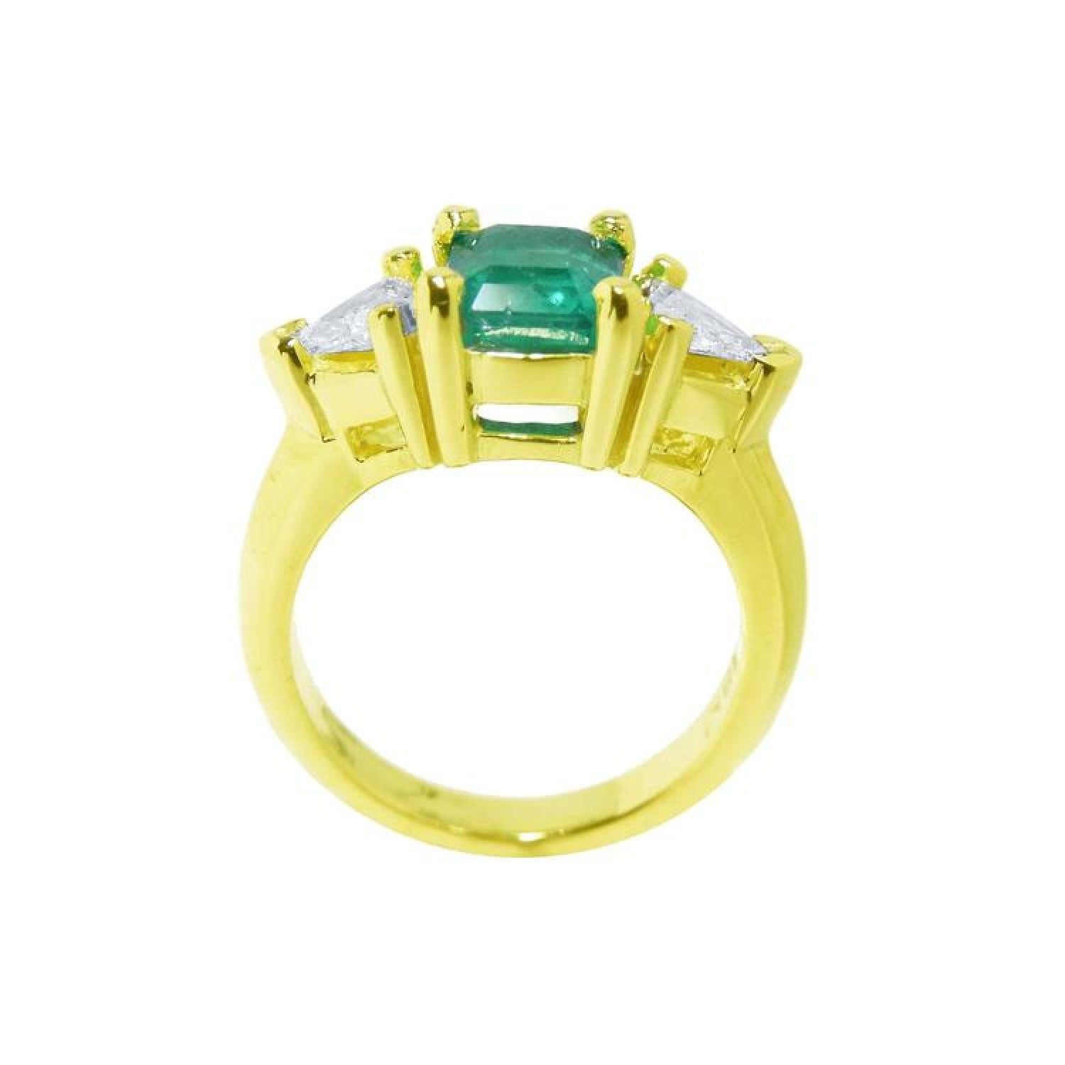 1.47 ct emerald-cut Colombian emerald ring with trillion diamonds in 18k yellow gold.