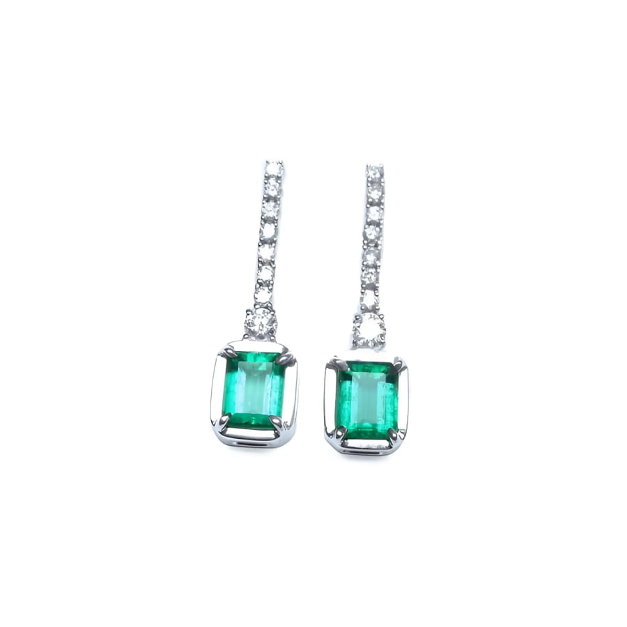 18K white gold dangling emerald-cut emerald earrings with diamond-studded lines.
