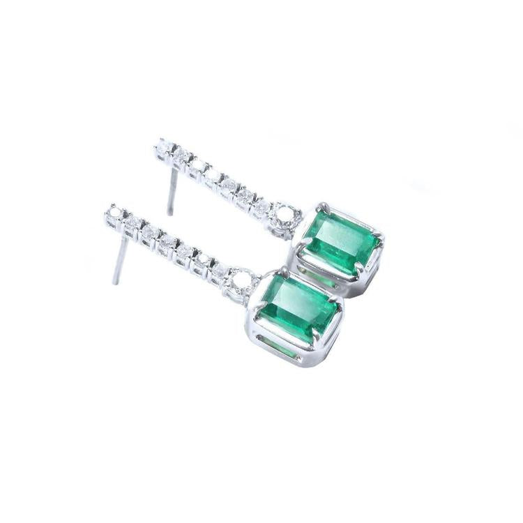 Pair of emerald earrings right side profile top and gallery view in white gold