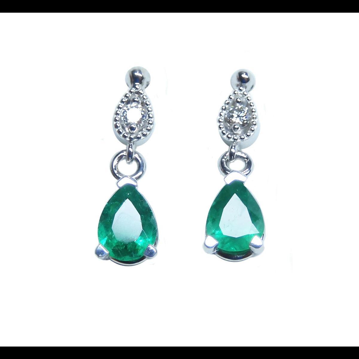 Front position of a pair of emerald teardrop earrings white gold plain top view