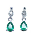 Front position of a pair of emerald teardrop earrings white gold plain top view