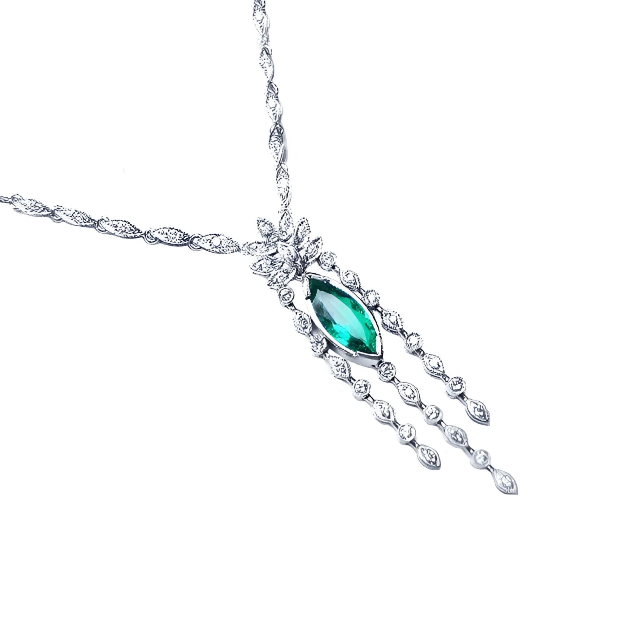 Marquise cut Colombian emerald necklace in 14K white gold with diamond links and floral accents.