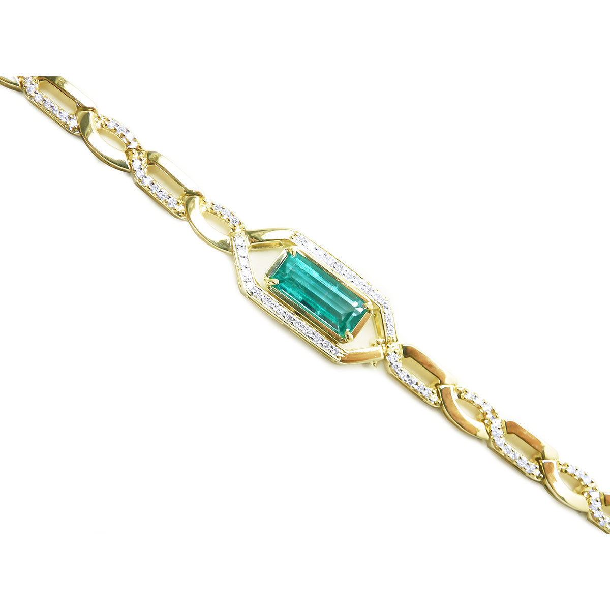 Gold bracelet with a baguette cut natural emerald and diamonds on a white background.