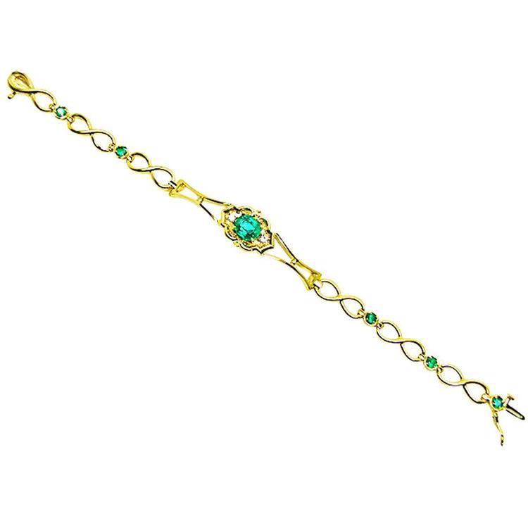 14K yellow gold bracelet with a central oval emerald and smaller emerald accents.