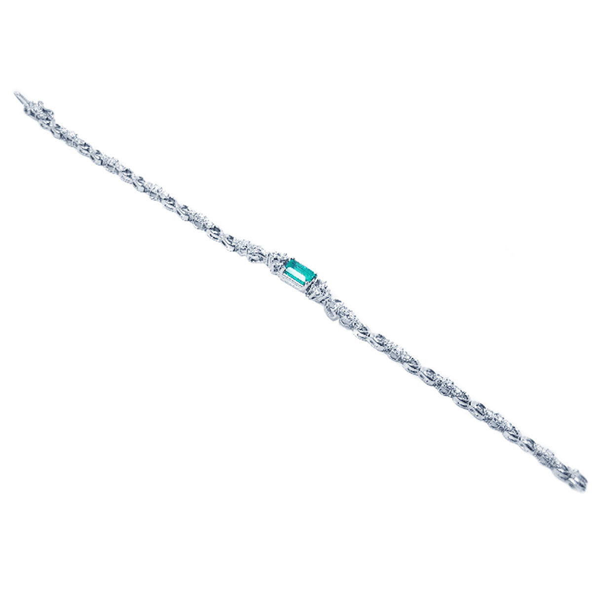 A distant view of a white gold bracelet with a central emerald gemstone on a white background.