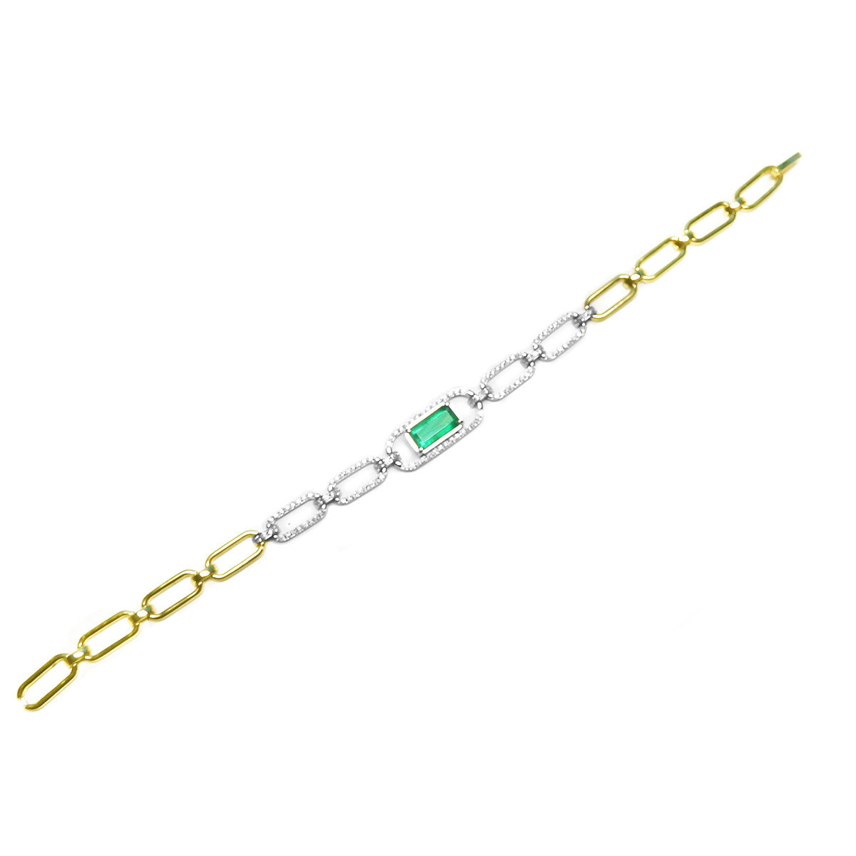 A distant view of this paperclip bracelet with white and yellow gold links and a green emerald and diamonds.