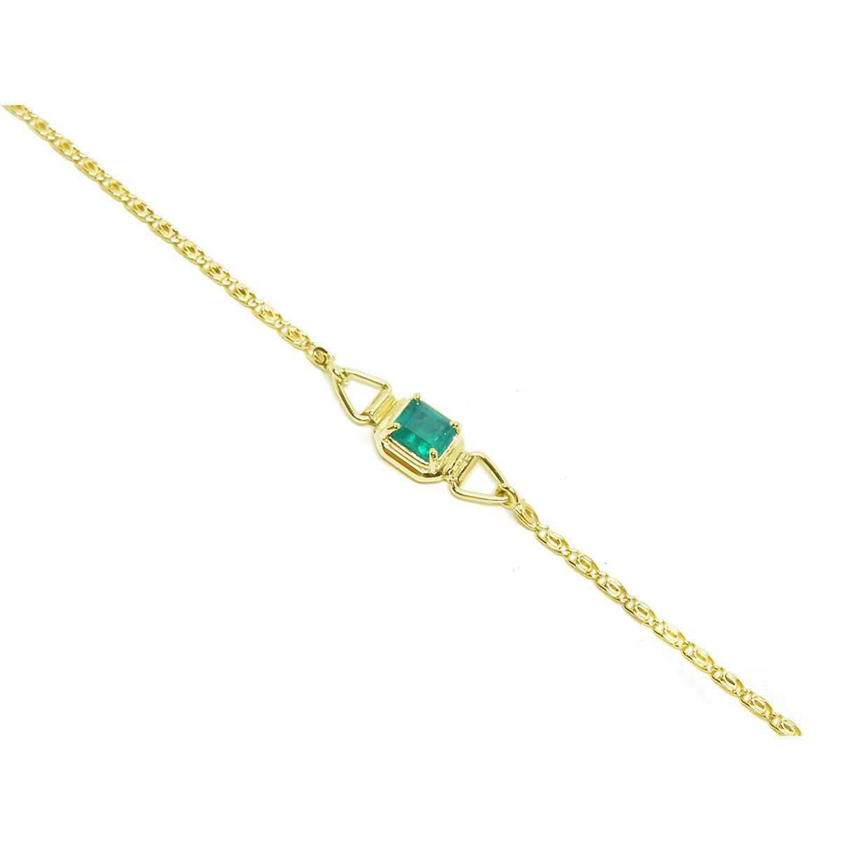 The distant view of a gold bracelet with a genuine emerald on a distant view.