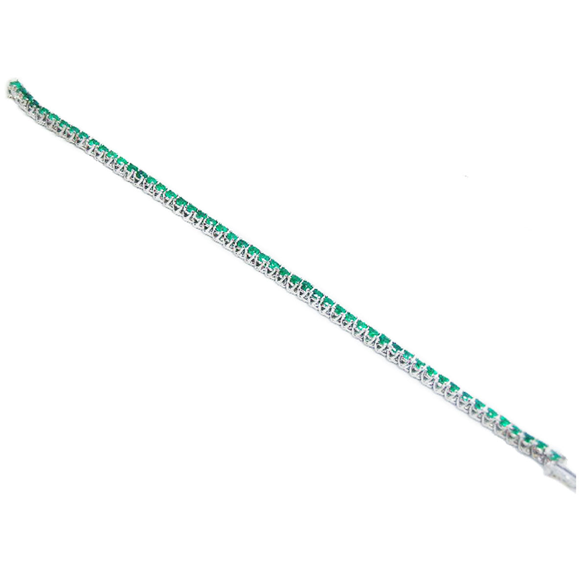 A distant view of a white gold bracelet with round cut natural emeralds on a white background
